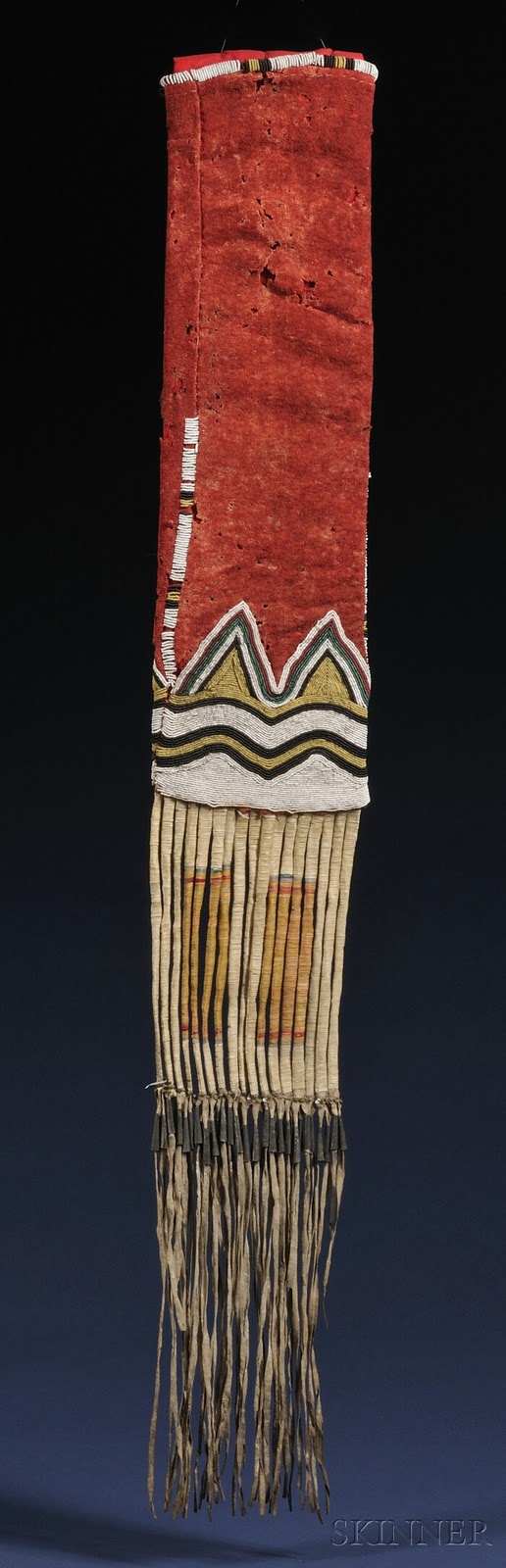 Yancton Beaded Cloth and Hide Pipebag, c. third quarter 19th century, the red trade cloth top beaded with curvilinear designs done in black, yellow, and white seed beads on one side, and black, yellow, white, translucent green, and red on the reverse, wit